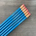 office woes personalized pencil set in aqua wood. multiple quotes. MATURE profanity. not for children or the easily offended. red erasers 