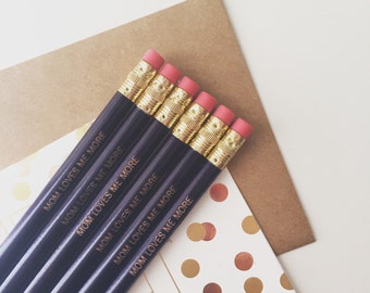 Mom loves me more engraved personalized pencils in dark violet. funny affordable gift for siblings