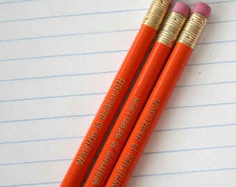 writing is rebellion pencil set of three 3 in orange. write your thoughts down and start a revolution