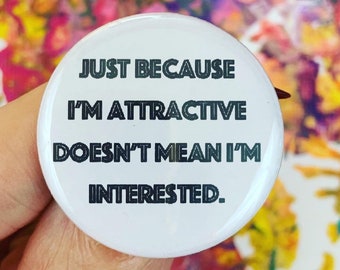 just because I’m attractive doesn’t mean I’m interested. 1.25 inch pinback button. aspec asexual funny button.