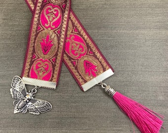 Book mark Skull witch core ribbon with moth charm.  hot pink and gold  ribbon. Black tassel. about 12 inches long. witch bookmark ooak