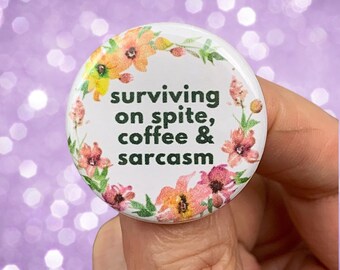 surviving on spite, coffee, and sarcasm 1.25 inch funny pinback button. Inspiration comes from everywhere babe but especially within.