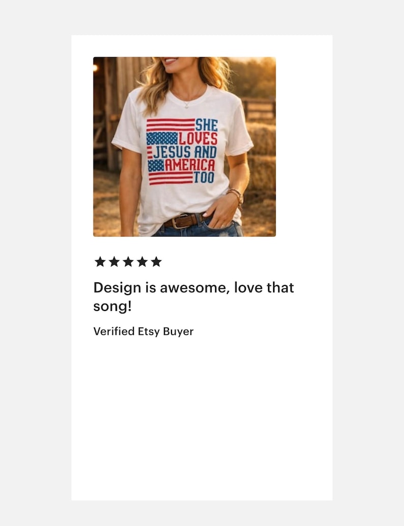 May include: White t-shirt with a patriotic design. The shirt features the text "She Loves Jesus and America Too" in blue and red, with American flag elements. The shirt is worn by a person.