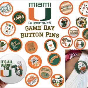 May include: A collection of Miami Hurricanes game day button pins in orange, green, and white. The pins feature various designs, including the team logo, text, and other graphics. One pin is attached to a person's clothing.