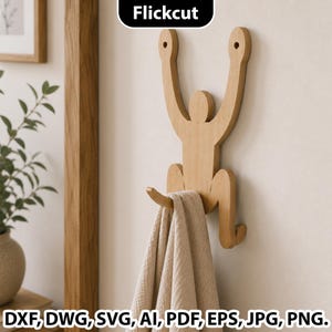 May include: A light-colored wooden wall hook shaped like a stylized human figure with arms raised and legs bent. The figure features two circular holes at the top for mounting and a curved hook at the base holding a folded beige fabric towel.
