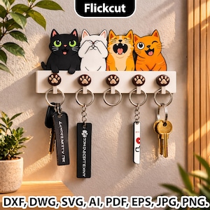 May include: A white key holder featuring four cartoon cat faces in black, white, orange, and yellow. The key holder has five key hooks with paw print accents. The image also includes the text "Flickcut" and file type abbreviations.