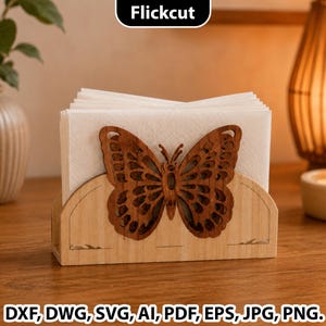 Puede incluir: Servilletero de madera con diseño de mariposa cortada con láser. El soporte es de madera de color claro y contiene una pila de servilletas blancas. La mariposa es de color marrón oscuro. El texto "Flickcut" está en la parte superior. El texto inferior dice "DXF, DWG, SVG, AI, PDF, EPS, JPG, PNG."