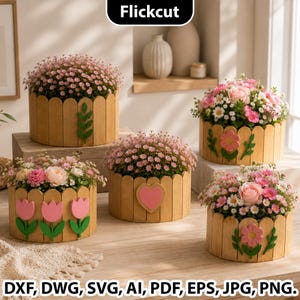 May include: Four round wooden planters with a picket fence design, each filled with pink and white flowers. The planters feature decorative wooden cutouts including a green leaf sprig, a pink heart, and pink tulips. Text reads Flickcut DXF, DWG, SVG, AI, PDF, EPS, JPG, PNG.