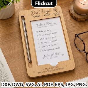 May include: A light-colored wooden daily planner board featuring a vertical slot for a silver pen. The board is engraved with the text Don't Forget, Today's Plan, and A LITTLE PLAN TODAY MAKES A BIG DIFFERENCE TOMORROW, alongside floral motifs.