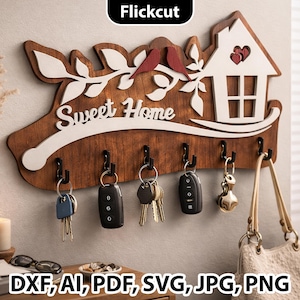 Pode incluir: Porta-chaves de madeira com um design de casa e pássaros, com o texto "Sweet Home". O porta-chaves tem seis ganchos e é decorado com detalhes em branco e vermelho. A imagem também inclui o texto "DXF, AI, PDF, SVG, JPG, PNG."