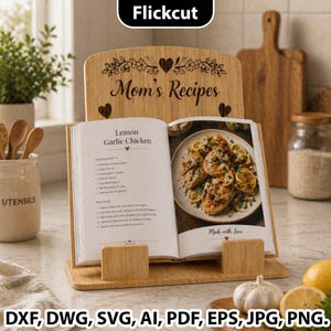May include: A bamboo cookbook stand with the text "Mom's Recipes" and a cookbook open to a recipe for Lemon Garlic Chicken. The cookbook stand has a heart and floral design. The image also includes lemons, garlic, and utensils.