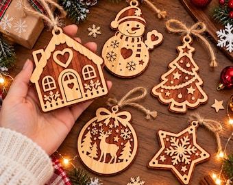 May include: A collection of five laser-cut wooden Christmas ornaments featuring a house, a snowman, a Christmas tree, a reindeer in a bauble, and a star with a snowflake. Each ornament has a light wood border and a dark wood center with twine.