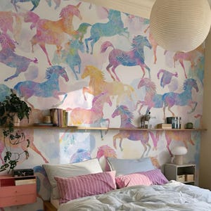 May include: A bedroom with a light blue comforter, pink and white striped pillows, and a white rug. The wall features a colorful horse pattern wallpaper. A large white paper lantern hangs from the ceiling.