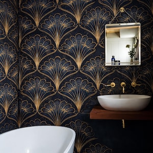 May include: A bathroom with a dark blue and gold Art Deco fan pattern wallpaper. The room features a white oval sink, a mirror, and a white bathtub. Gold fixtures and a wooden shelf add to the luxurious feel.