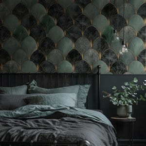 May include: A bedroom scene featuring a bed with gray bedding and pillows. The headboard is black, and the wall behind it is decorated with a dark green and gold fan-shaped wallpaper. Two light bulbs hang from the ceiling.