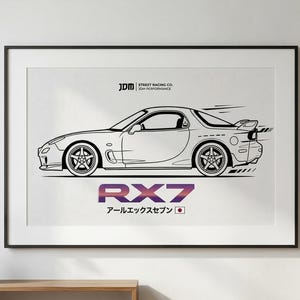 May include: Framed black and white line drawing of an RX7 sports car. The car is depicted in profile with details like wheels and a spoiler. The text "RX7" is in a gradient color, with Japanese text and a Japanese flag below.