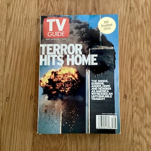 May include: A September 2001 issue of TV Guide magazine with a cover image of the World Trade Center towers on fire. The headline reads "Terror Hits Home".
