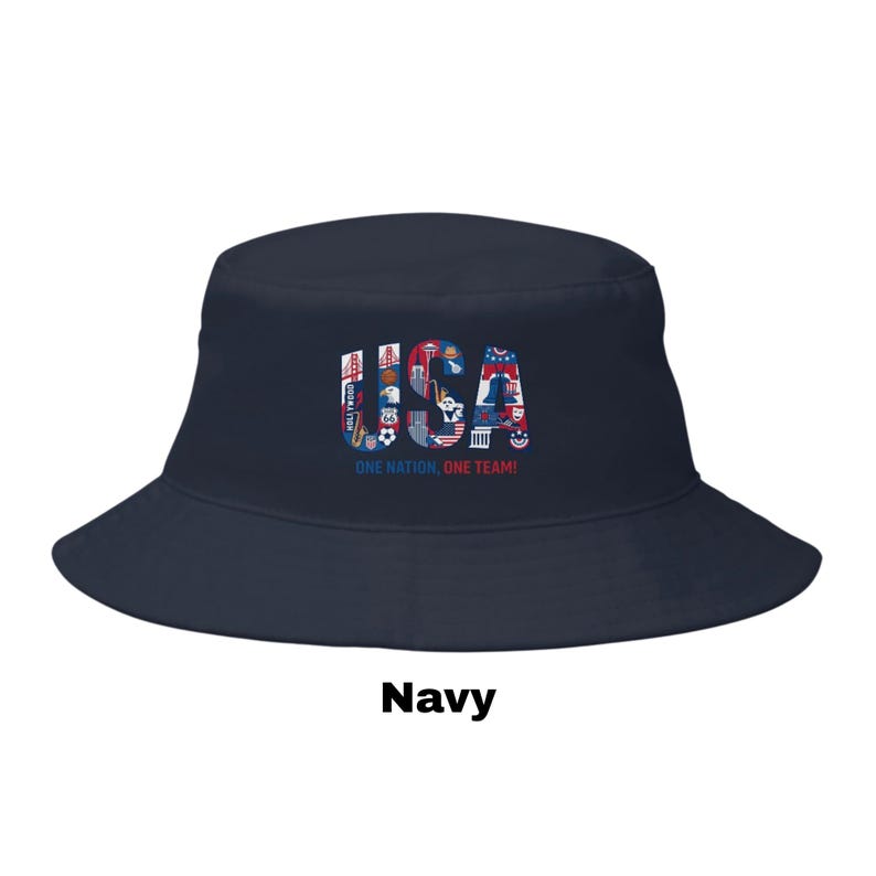 May include: Navy blue bucket hat with the word "USA" in a colourful design. The hat features the text "ONE NATION, ONE TEAM!" in white. A stylish accessory for sports fans.