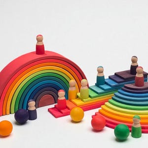 May include: A set of colourful wooden toys including a rainbow arch, steps, and circular structures. Small wooden peg people and spheres are also included. A creative toy for children.