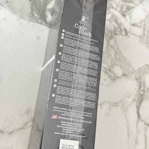 May include: A black rectangular box with the text "IC Code Black" in white. The box has a list of ingredients and other information printed on it. The box is designed and developed in the USA.