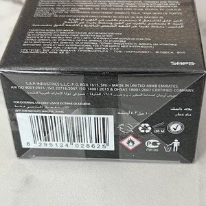May include: Black rectangular box of "Stately May Deluxe" perfume. The box has text in multiple languages, including English, Arabic, and Ukrainian. It includes a barcode and safety symbols. The product is 4.3 fl oz.
