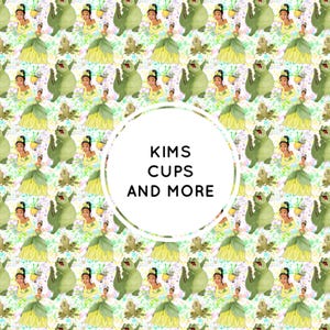May include: A repeating pattern featuring a cartoon princess in a yellow dress and a green frog character against a white background with green and purple paint splatters. A central white circle contains the black text KIMS CUPS AND MORE.