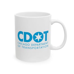 May include: White ceramic mug with a blue logo that reads "CDOT CHICAGO DEPARTMENT OF TRANSPORTATION". The mug has a curved handle and a cylindrical shape. The logo includes a star.