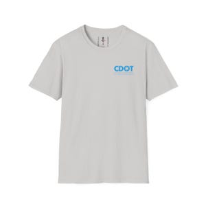 May include: A light gray crew neck t-shirt with short sleeves. The shirt features the text "CDOT" in blue, with a star symbol and the words "CHICAGO DEPARTMENT OF TRANSPORTATION" below it. The shirt is made of a soft material.