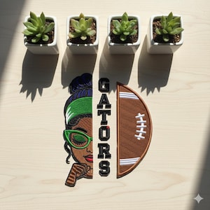 May include: An embroidered patch showing a woman with green sunglasses and a football. The word "GATORS" is vertically displayed. Four small square white planters with succulents are arranged above the patch.