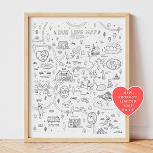 May include: A black and white line art print titled Our Love Map featuring Mike and Julie, depicting various milestones with illustrations of houses, pets, and travel scenes connected by winding roads, framed in a light wood frame.