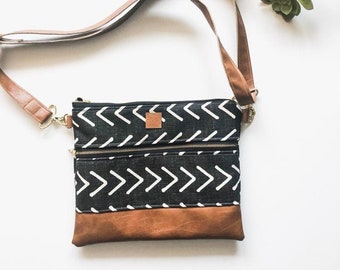 Mudcloth black and white arrow crossbody bag with front zipper and faux leather brown