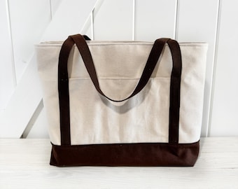 Cream Canvas Tote bag with dark brown bottom and brown cotton straps interior is solid cream