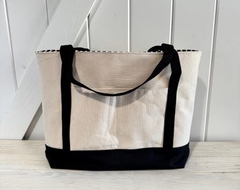 Cream Canvas Tote bag with black bottom and black cotton straps and striped interior
