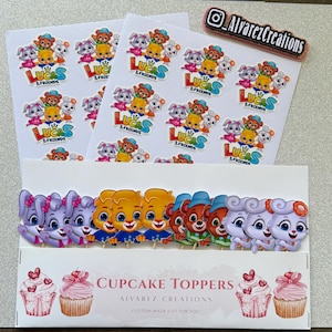 May include: Sheets of stickers and cupcake toppers featuring cartoon characters from "Lucas & Friends." The stickers and toppers have a variety of colorful animal characters. The cupcake toppers are displayed in a white box with the text "Cupcake Toppers."