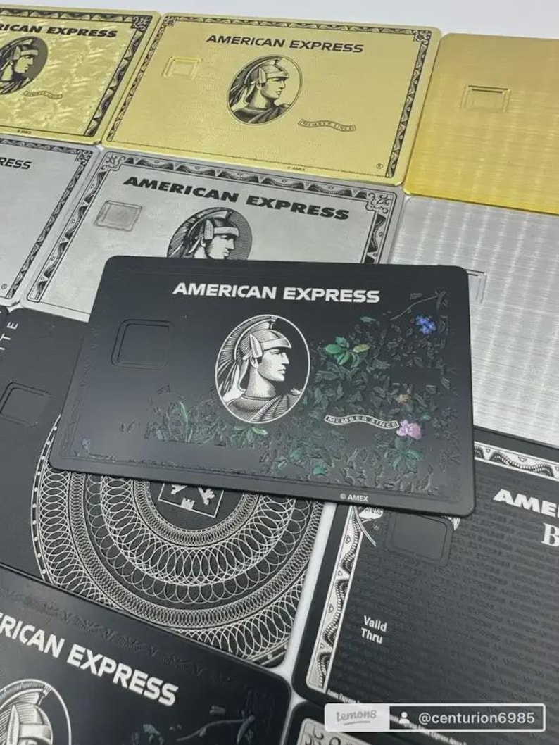 May include: An assortment of American Express credit cards in gold, silver, and black. Each card features the American Express logo and a profile of a Roman centurion. Some cards have floral designs.