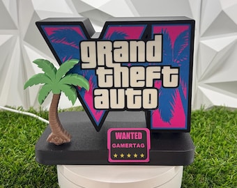 May include: A black and pink Grand Theft Auto V logo sign featuring a palm tree on the left side. A small rectangular pink sign attached to the base displays the text WANTED GAMERTAG with five yellow stars underneath the text.