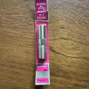 May include: A vintage Cutex lipstick in a pink and silver box. The box reads "New Formula Ultra Smooth No. 7". The lipstick is in a silver metallic tube. The box also states "Card colour is actual shade".