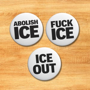 May include: A white ceramic mug with a black handle and the text "But First, Coffee" in a black, bold font. The mug is sitting on a white surface. The mug is likely used for drinking coffee or tea.