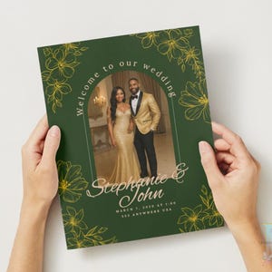May include: A dark green wedding invitation with gold floral detailing and the words "Welcome to our wedding." The invitation features a photo of a couple in formal attire. The names "Stephanie & John" are displayed in elegant script.