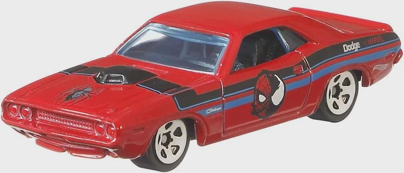 May include: A red Dodge Challenger toy car with black and blue stripes, a Spider-Man graphic, and the Marvel logo. The hood features a black air intake and a spider emblem. The car has white-rimmed wheels.