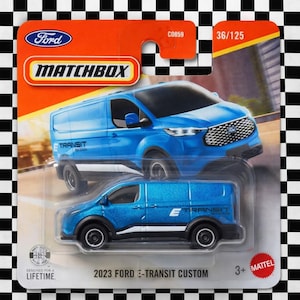 May include: A Matchbox die-cast toy car of a 2023 Ford E-Transit Custom van. The van is blue with black wheels and white accents. The packaging is orange and white with the Ford and Matchbox logos. The text "E-Transit Custom" is visible.