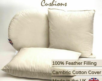 May include: Off-white duck feather cushions in various shapes. The image shows a square, a rectangular, and a half-circle cushion. Text on the image reads "Duck Feather Cushions", "100% Feather Filling", "Cambric Cotton Cover", and "Made in the UK".