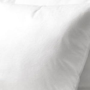 May include: Close-up of a white pillow with a soft, textured surface. The pillow is square-shaped and appears to be made of a smooth fabric. The lighting creates subtle shadows, highlighting the pillow's shape and texture.