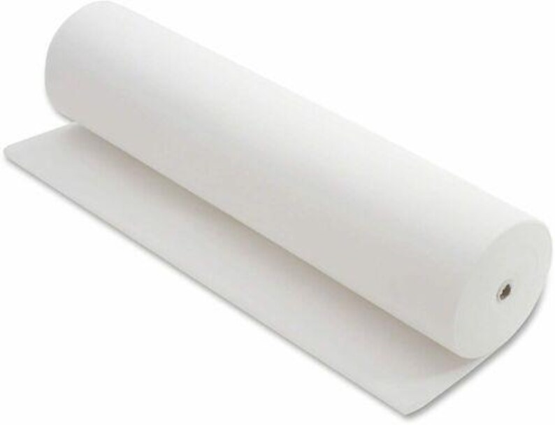 May include: A roll of white felt fabric, partially unrolled, showing the texture and thickness of the material. The felt is a solid, bright white color, and the roll is cylindrical.