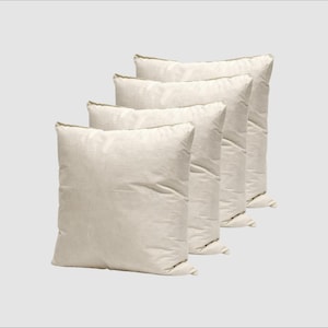 May include: Four off-white square cushions arranged diagonally. The cushions have a soft, textured appearance, possibly made of linen or cotton. The neutral colour and simple design suggest a focus on comfort and versatility for home decor.