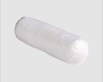 May include: A white, cylindrical bolster pillow. The pillow is made of a soft, textured fabric and is designed to provide support. The pillow is a solid white color and has a rounded shape.
