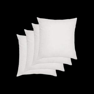 May include: Four square, white cushion pads are stacked against a black background. The pads are fluffy and appear to be made of a soft material. The pads are a neutral colour and can be used for decorative purposes.