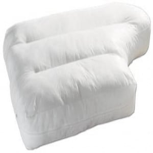May include: A white, shaped pillow with a quilted surface. The pillow has a distinctive form, with three raised sections and a curved edge. The design suggests it is intended to provide support and comfort for the head and neck during sleep.