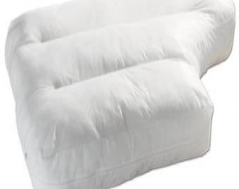 May include: A white, plush, L-shaped pillow featuring a soft, quilted fabric surface with distinct horizontal stitched channels. The pillow has a rounded, extended arm section and a rectangular base, providing a structured yet cushioned form.