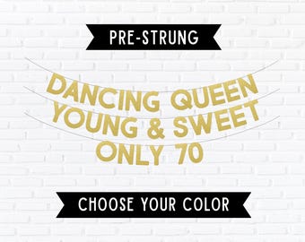 May include: A pre-strung banner featuring gold glitter letters that spell out DANCING QUEEN YOUNG & SWEET ONLY 70. The banner is arranged in three horizontal lines with black banners at the top and bottom containing the text PRE-STRUNG and CHOOSE YOUR COLOR.